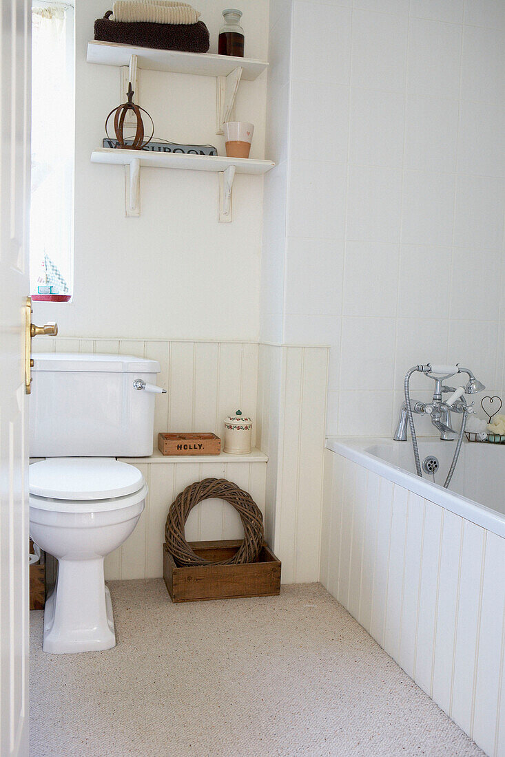 Cream panelled bathroom with pedestal base toilet