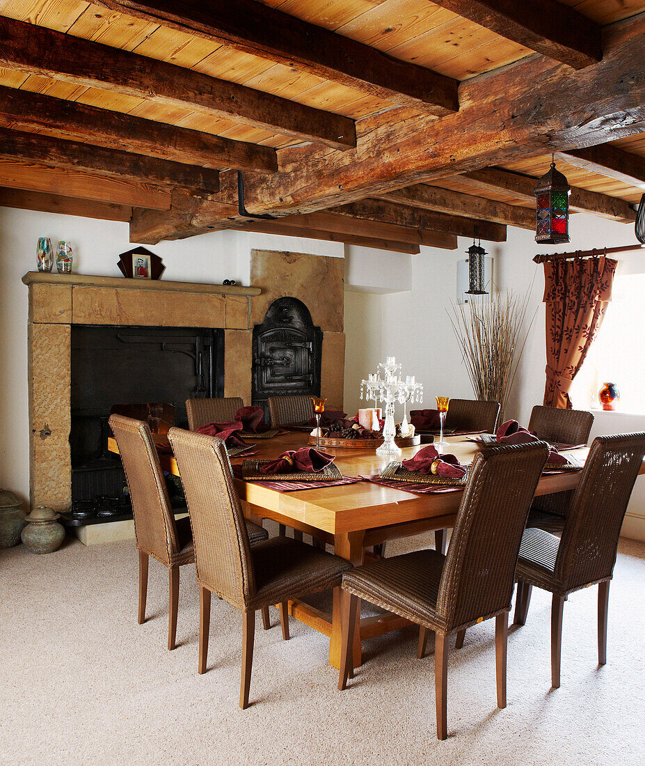 beamed ceiling in country style dining room with table and chairs