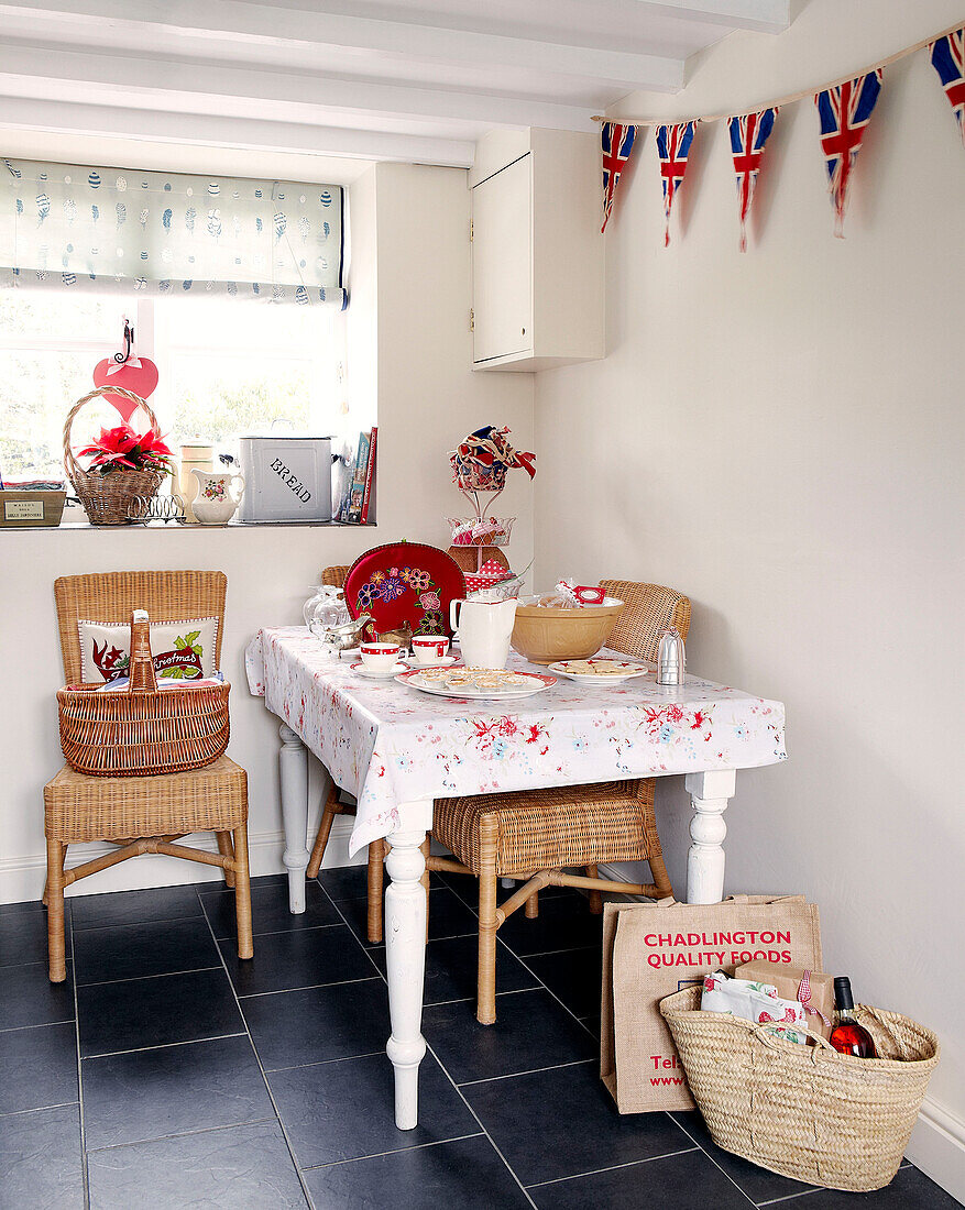 Wicker chairs and basket in kitchen with Union Jack bunting