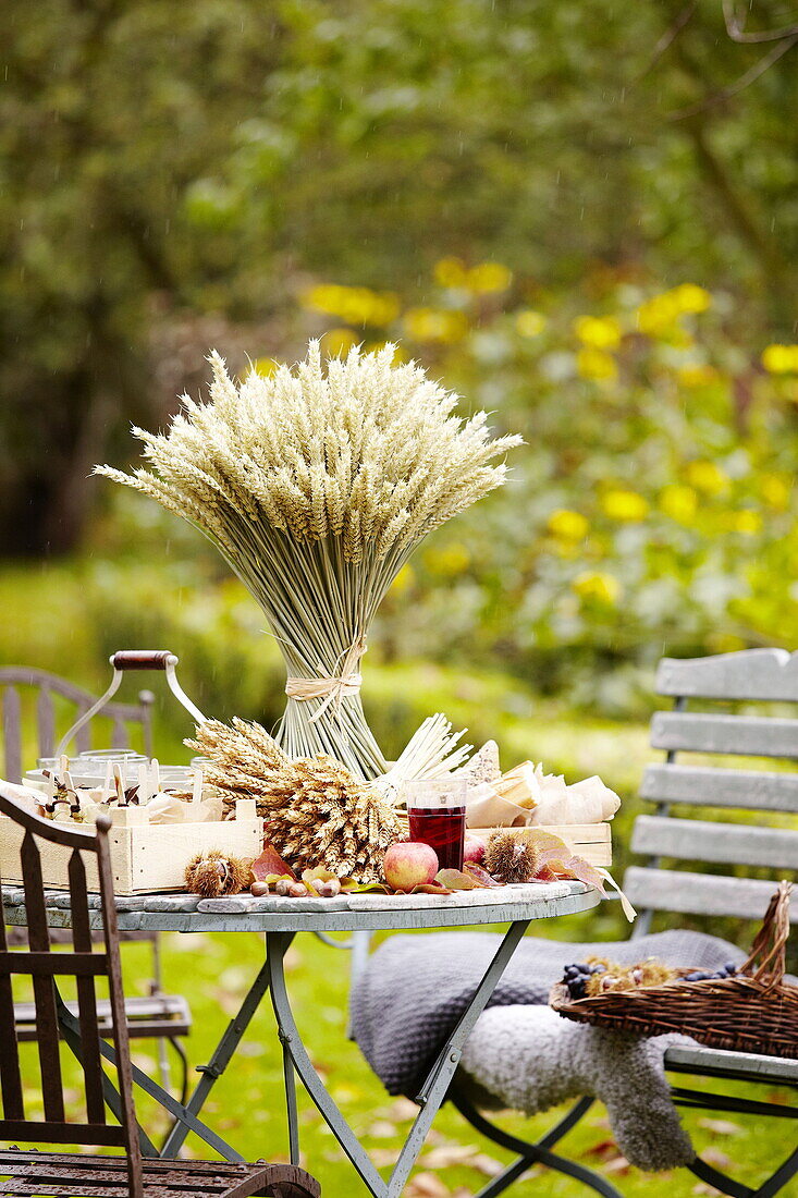 Dried grasses and crates on table in Essex garden England UK