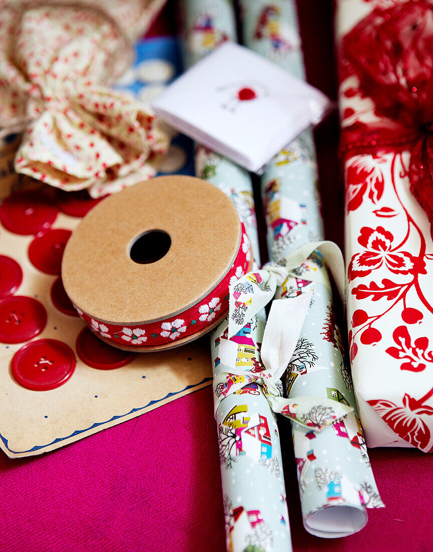 Embroidered ribbon and wrapping paper with red buttons