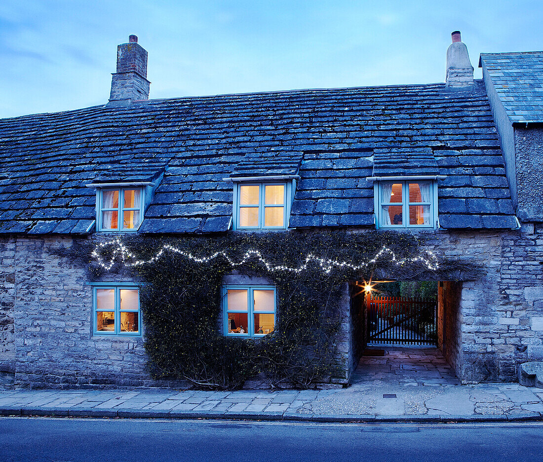 Fairy lights on stone exterior of country house