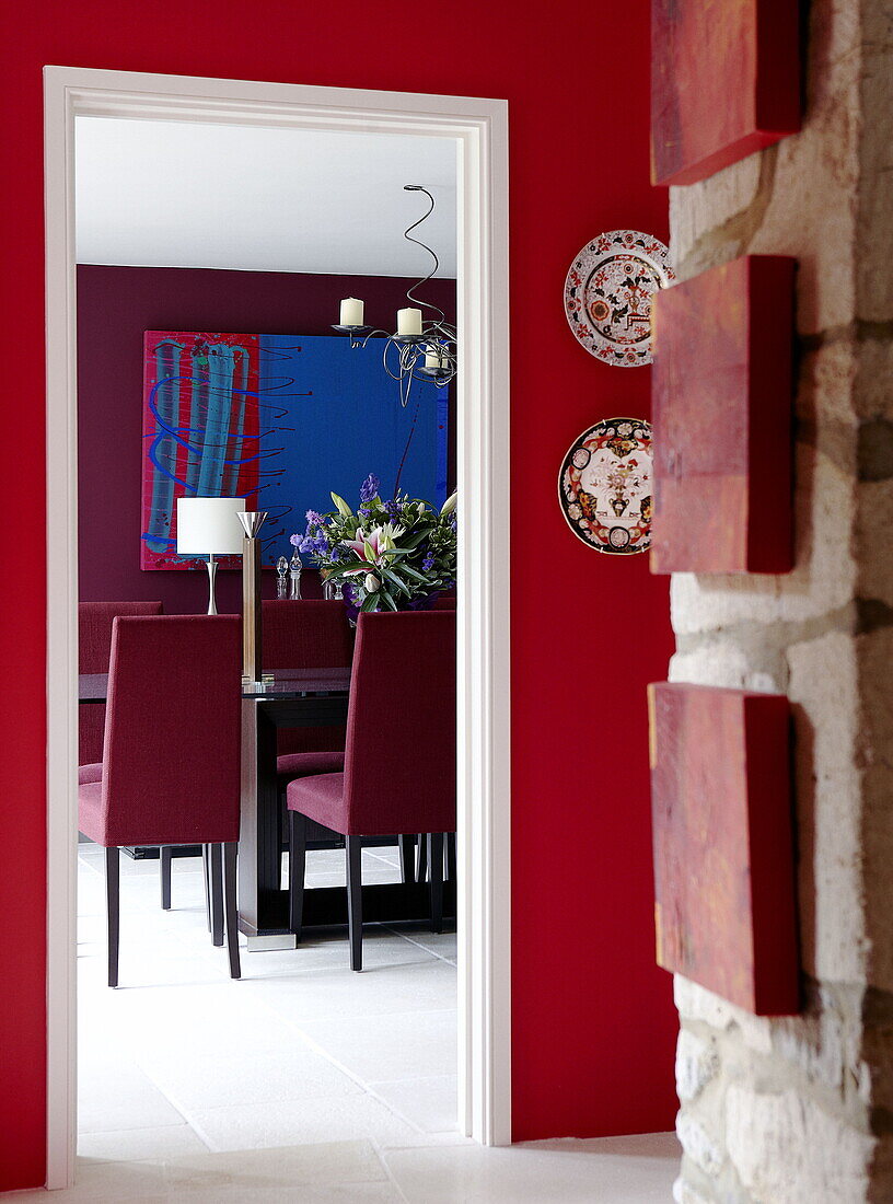 View through doorway to dining room in renovated Cotswolds mill house England UK