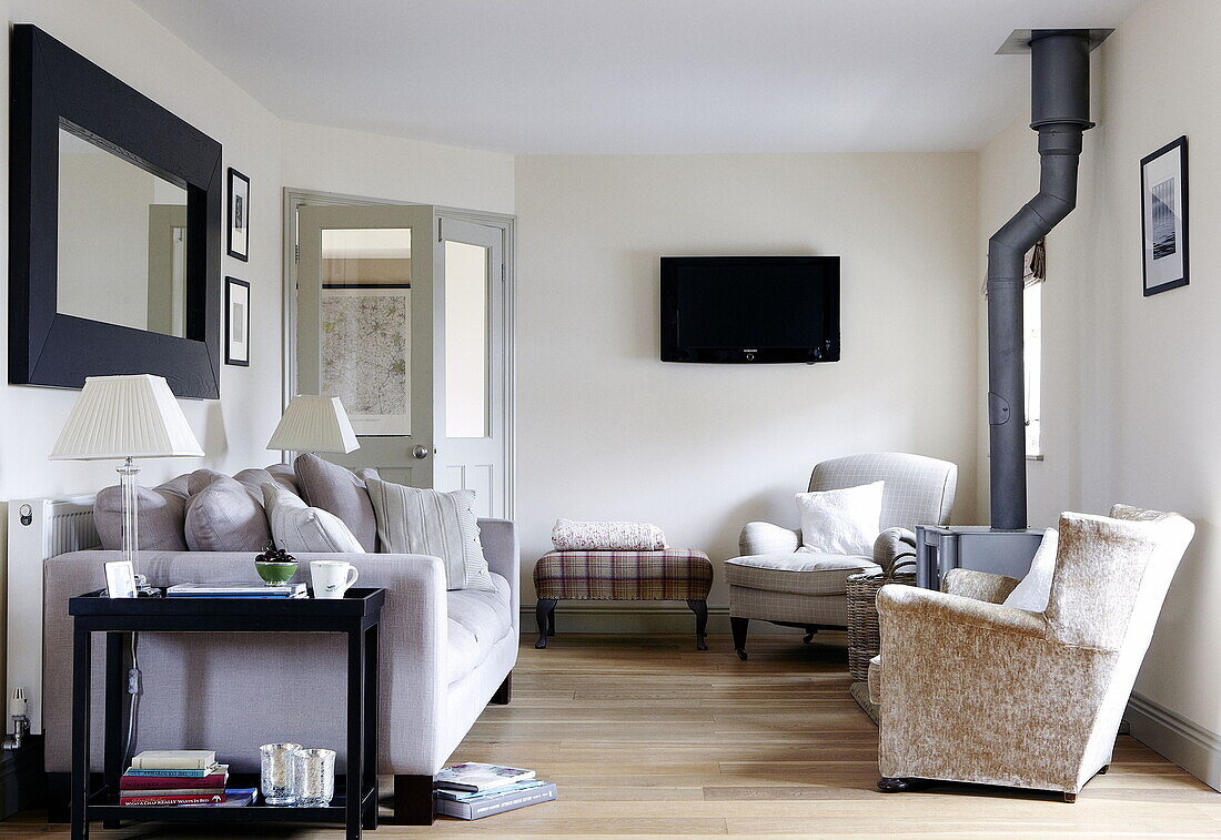 Lilac sofa and armchairs in living room of Durham family home England UK