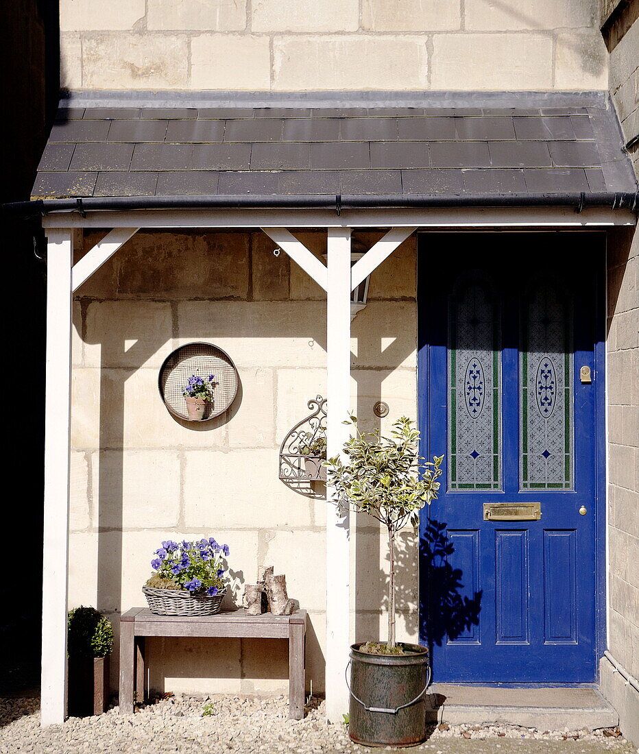 Porch entrance with blue front door of home in the City of Bath Somerset, England, UK