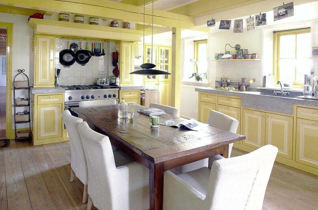 Yellow kitchen with table for six in Abbekerk Dutch province of North Holland in the municipality of Medemblik