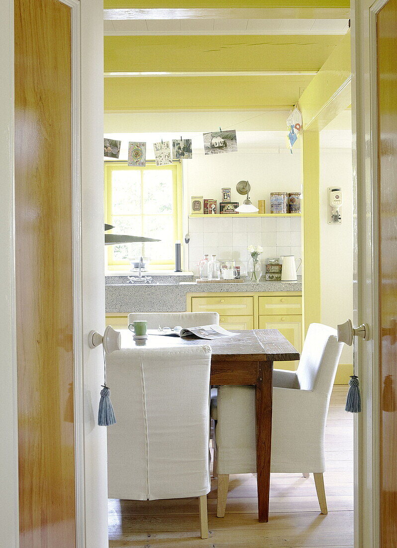 Yellow kitchen with table in Abbekerk Dutch province of North Holland in the municipality of Medemblik