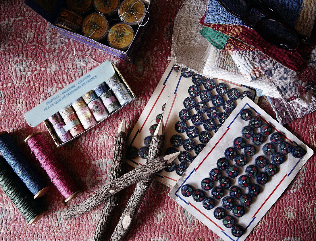 Buttons and vintage bobbins with fabric samples in home of London textiles designer UK