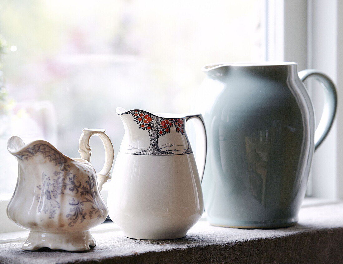 Three milkjugs on windowsill of Hexham country house Northumberland England UK