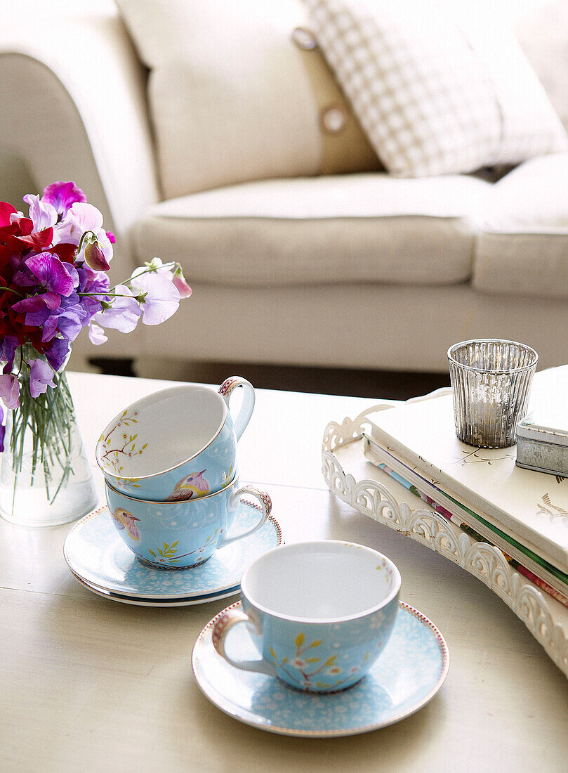 Teacups and saucers with sweet William on coffee table of Oxfordshire home, England, UK