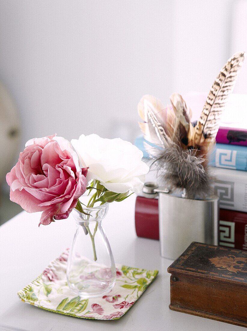 Cut roses on desk with hip flask and quills in Staffordshire home, England, UK