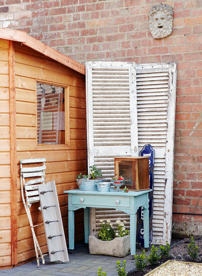 Louvered doors with upcycled table and garden shed