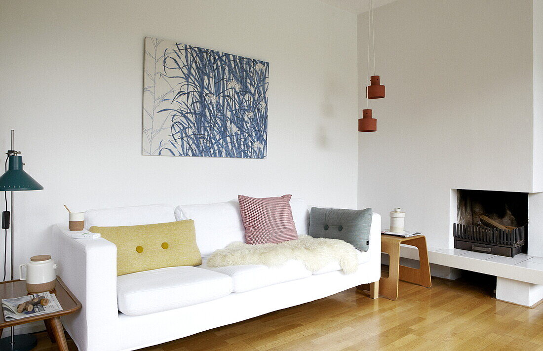 Artwork canvas above white sofa at fireside in living room of Bussum home, Netherlands