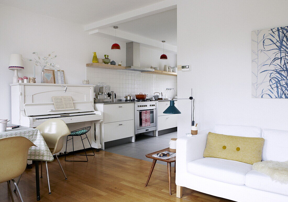 Offene Küche und Esszimmer mit weißem Klavier in einem Haus in Bussum, Niederlande