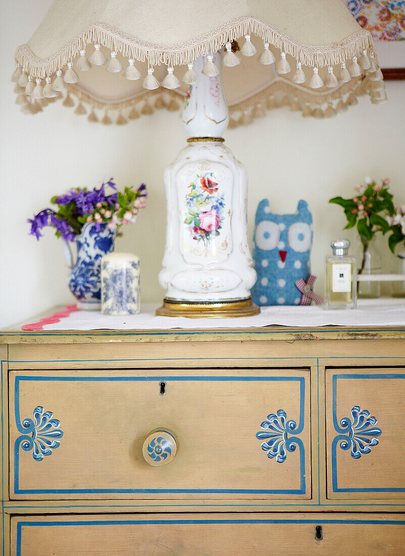 China lamp on upcycled chest of drawers in Oxfordshire farmhouse bedroom England UK