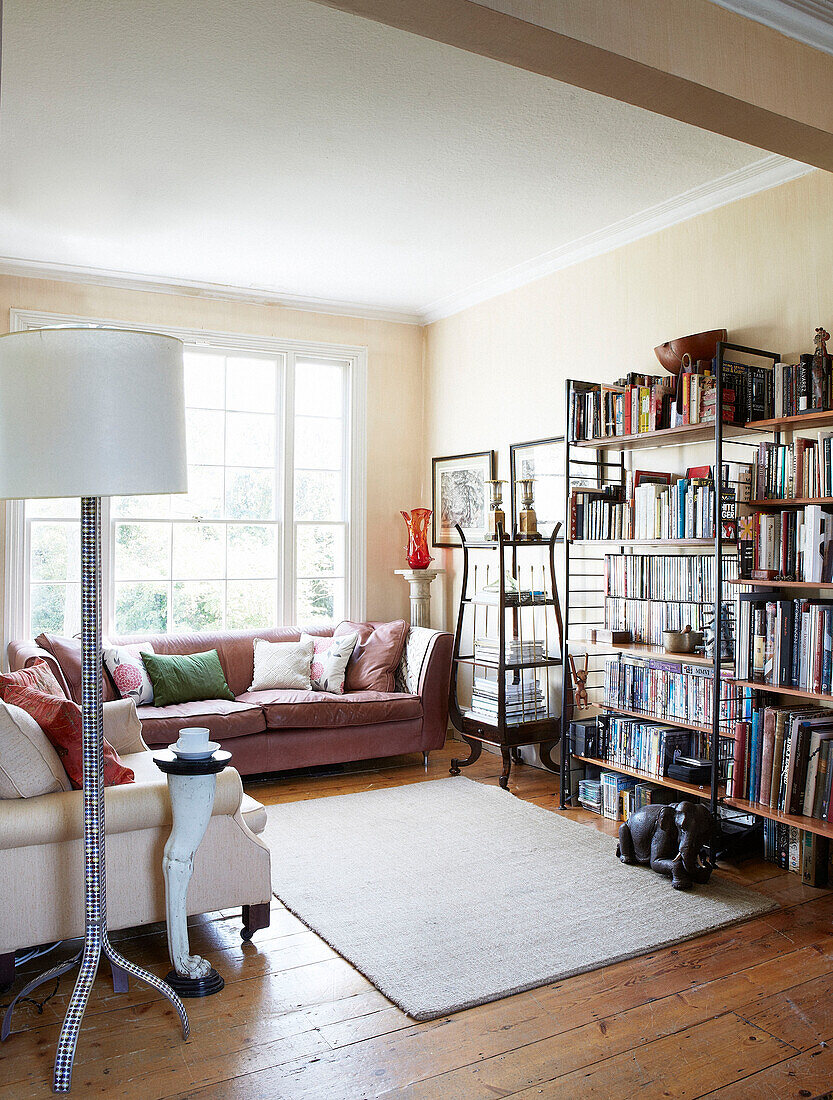 Bookshelves and rug with sofas in living room London townhouse England UK