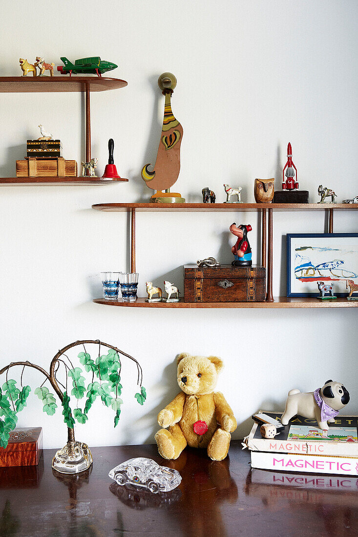 Child's toys on wall mounted shelving in London townhouse England UK