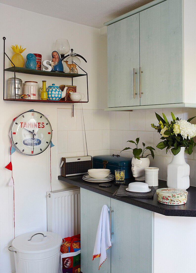 Kitchenware and clock with fitted units in kitchen of family home in Margate Kent England UK