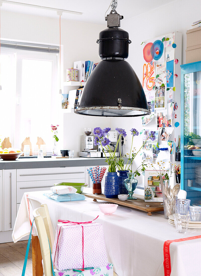 Black pendant lamp above table in kitchen of Mattenbiesstraat family home, Netherlands