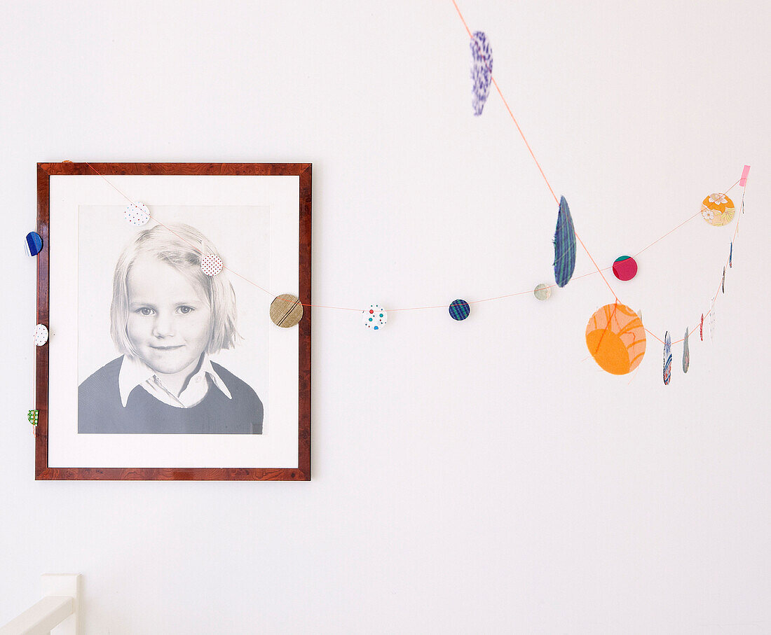 Portrait of a schoolgirl and paper chain in Mattenbiesstraat family home, Netherlands