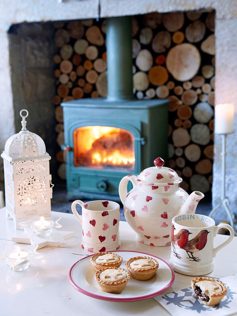 Mince pies and tea in front of woodburning stove in Derbyshire farmhouse England UK