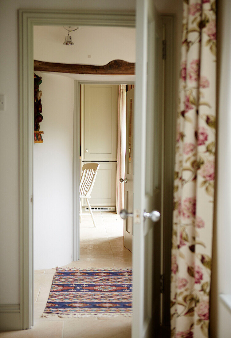 View across hallway through doorways in rural Oxfordshire cottage England UK