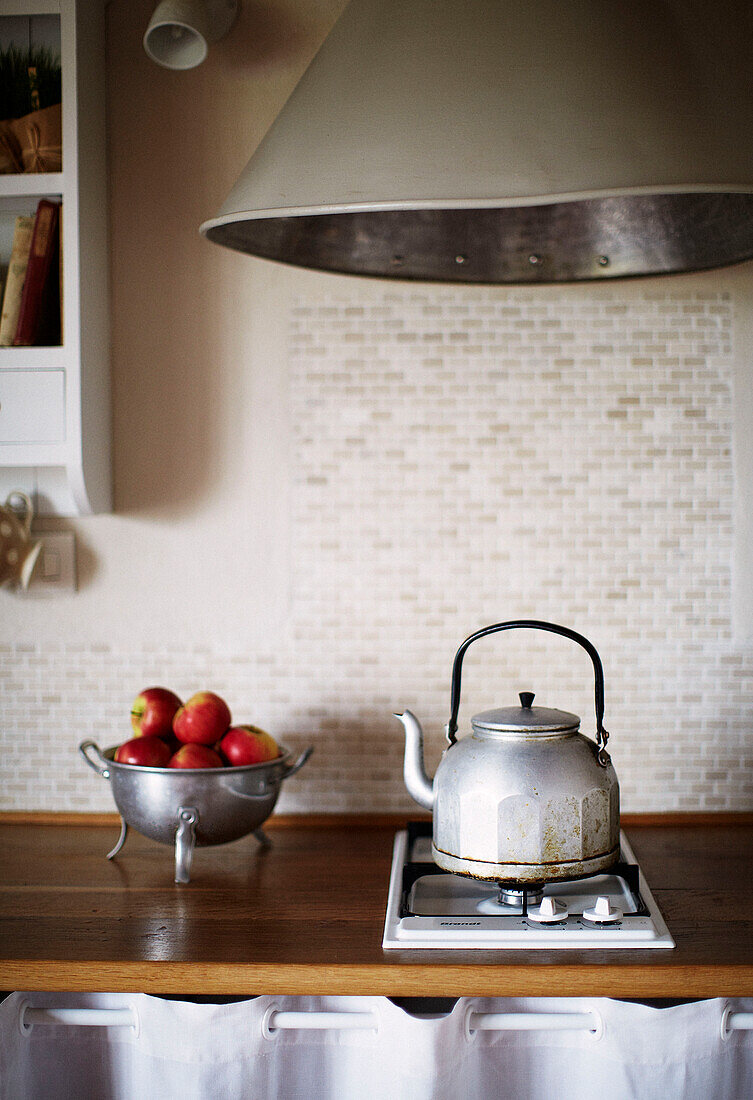 Colander of apples and kettle on gas hob in Brittany kitchen France