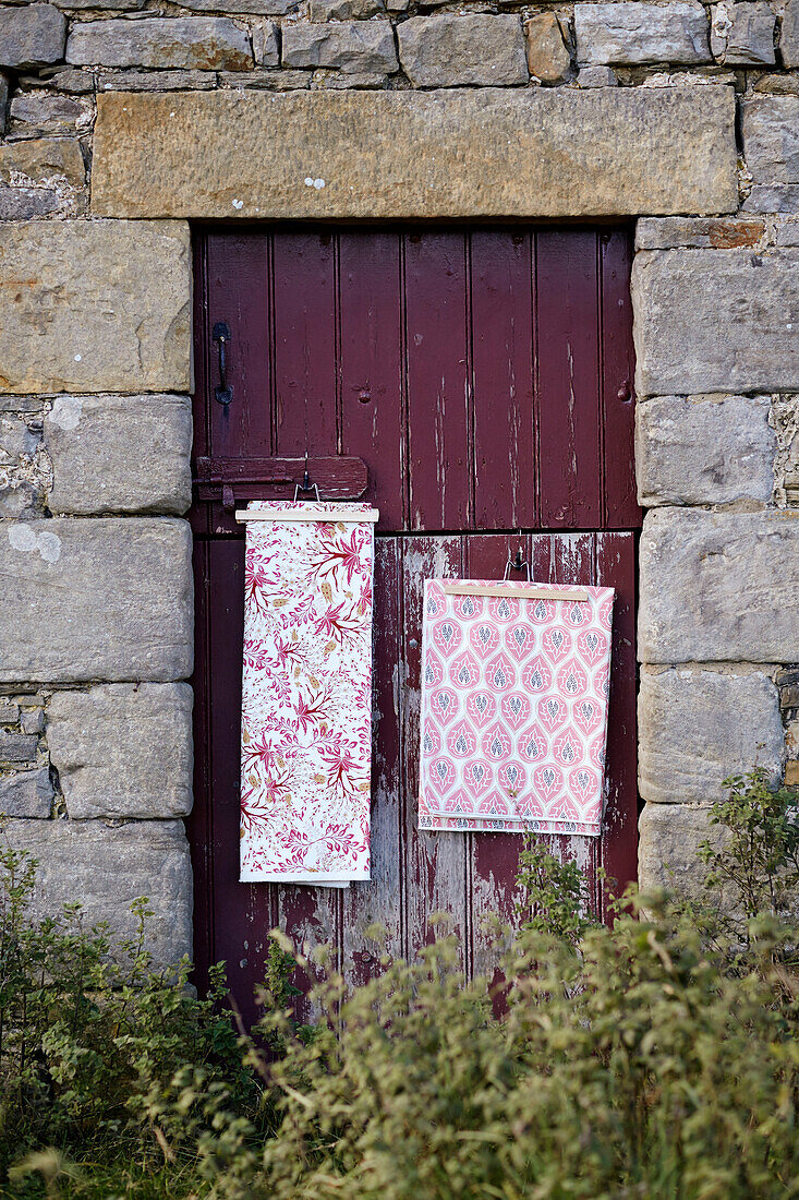 Fabric samples in stable door of derelict Northumbrian farmhouse England UK