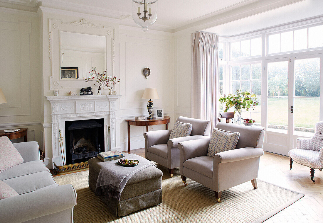 Pair of armchairs at fireside in Bicester living room Oxfordshire England