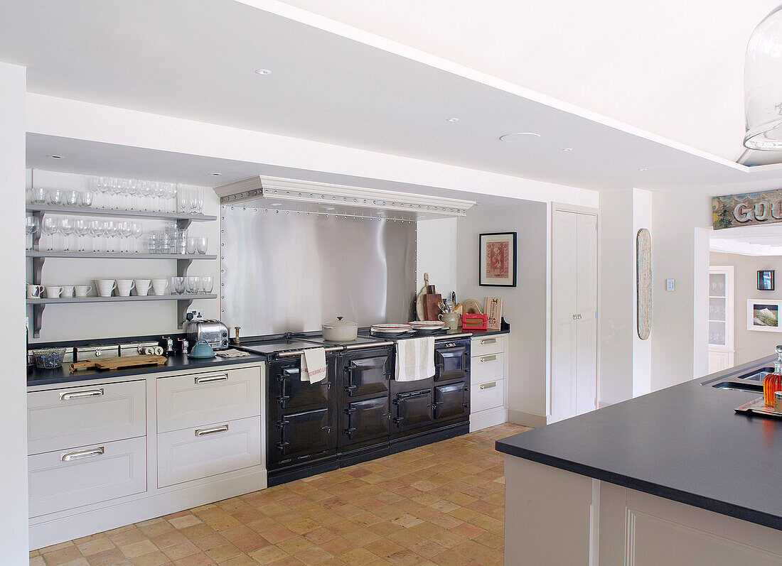 Stainless steel splashback above black range oven in spacious Buckinghamshire kitchen UK