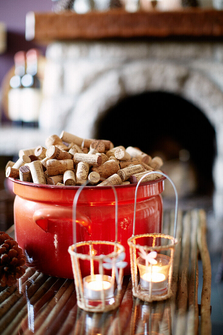 Saucepan of corks and lit tealights in Brittany guesthouse France