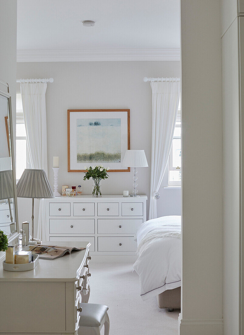 Lamps on dressing table and chest of drawers in bedroom detail of York townhouse England UK