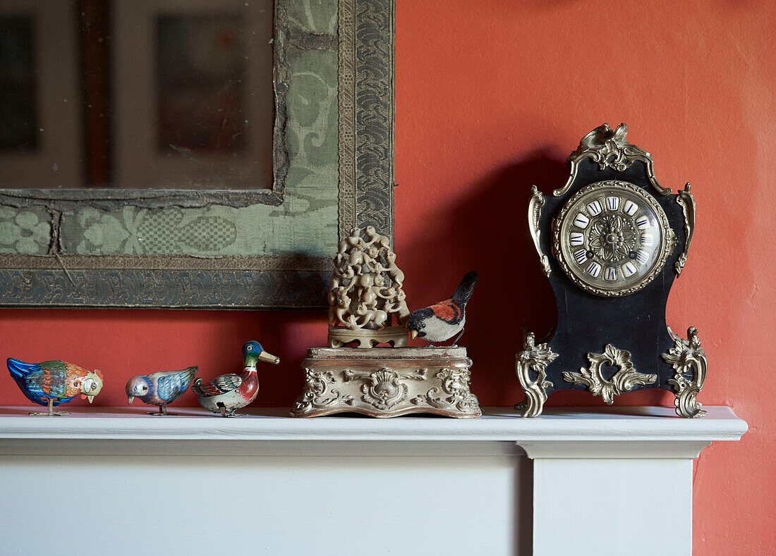 Duck and bird ornaments with antique clock on mantlepiece in 19th century Georgian townhouse in Talgarth, Mid Wales, UK