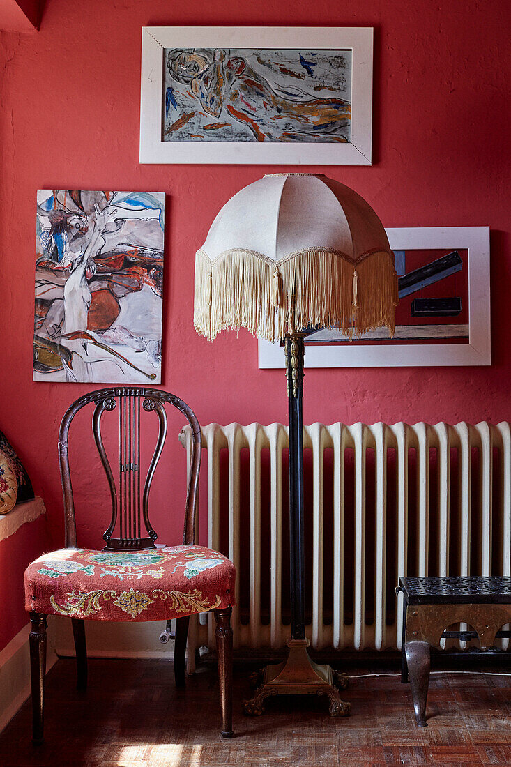 Standard lamp and upholstered chair with artwork in Powys cottage, Wales, UK