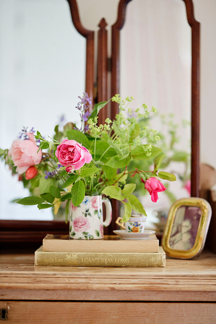 Summer flowers on dressing table in Sandford St Martin cottage, Oxfordshire, UK