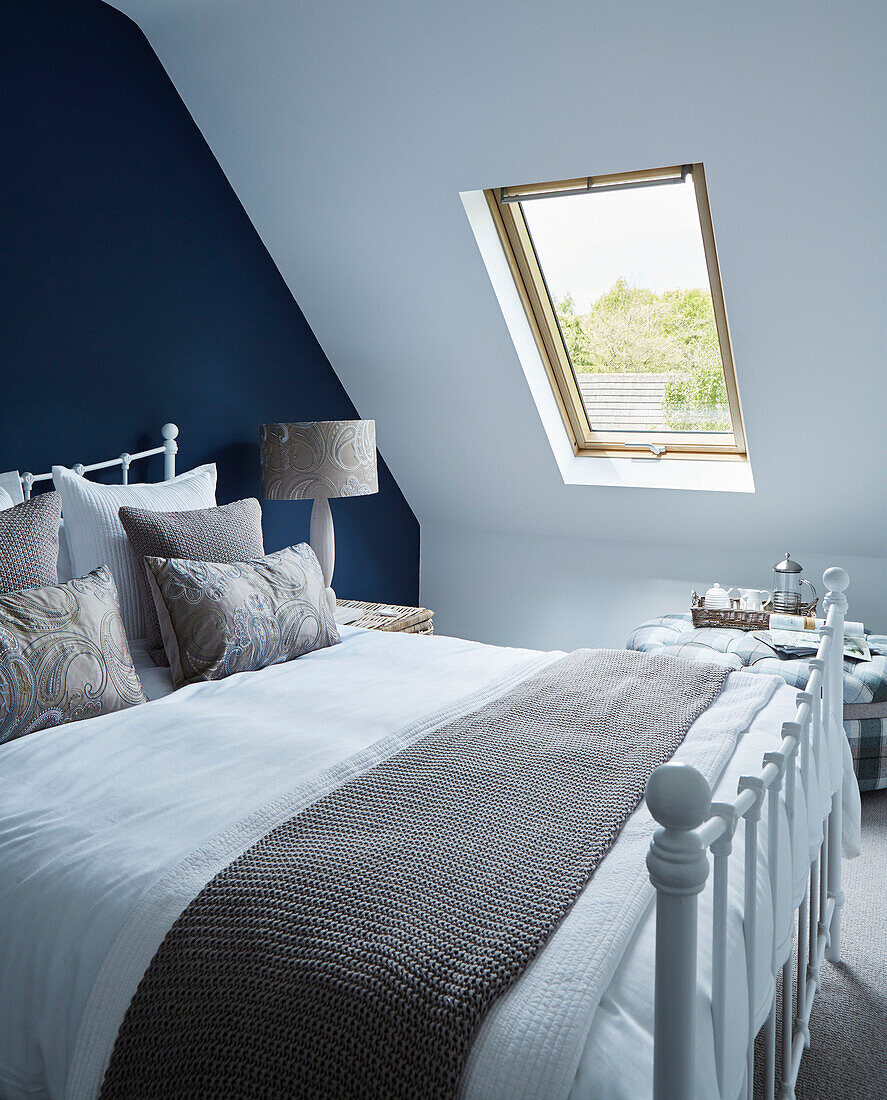 Blue and beige attic bedroom in detached North Yorkshire home, UK