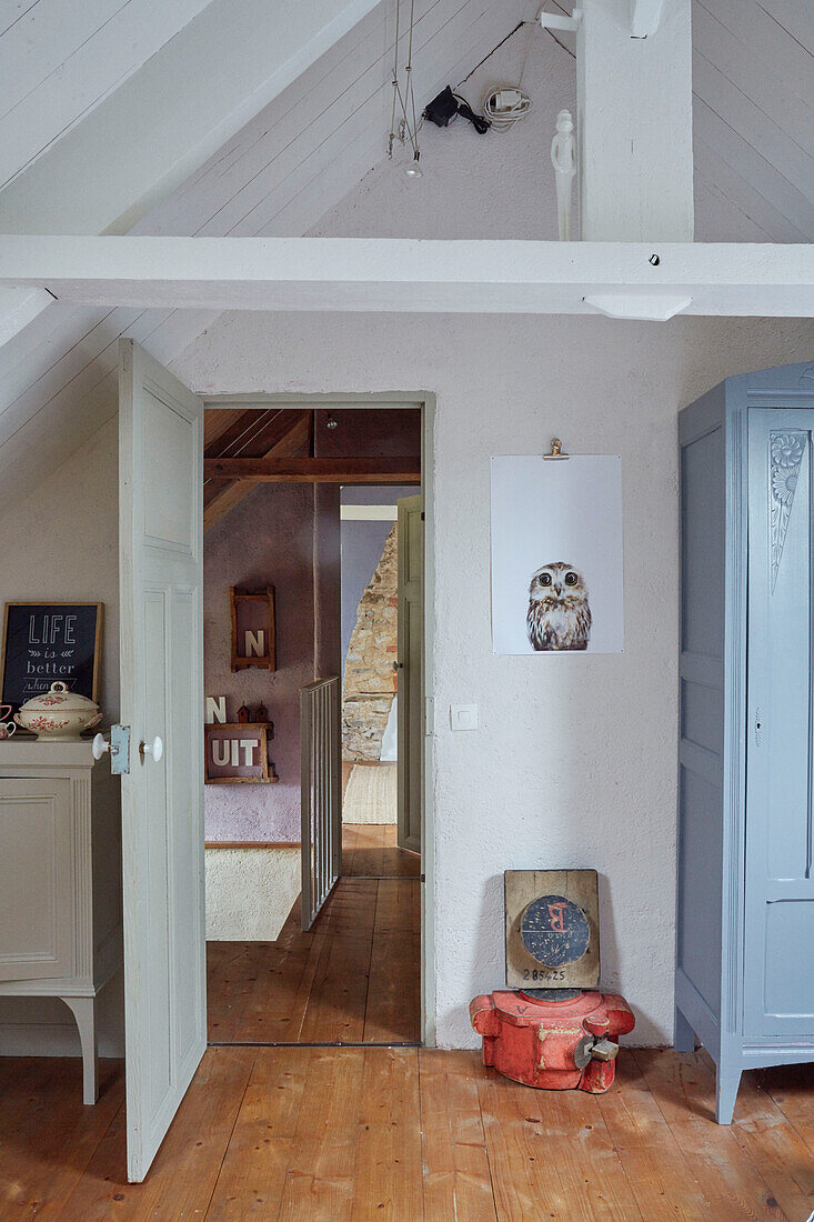 View through open doorway with wooden floorboards in Brittany cottage, France