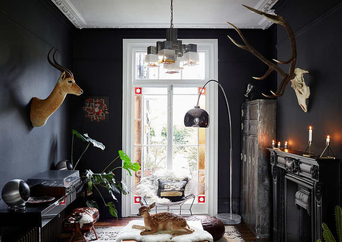 Animal heads and record player with arco lamp in Ramsgate home Kent, UK