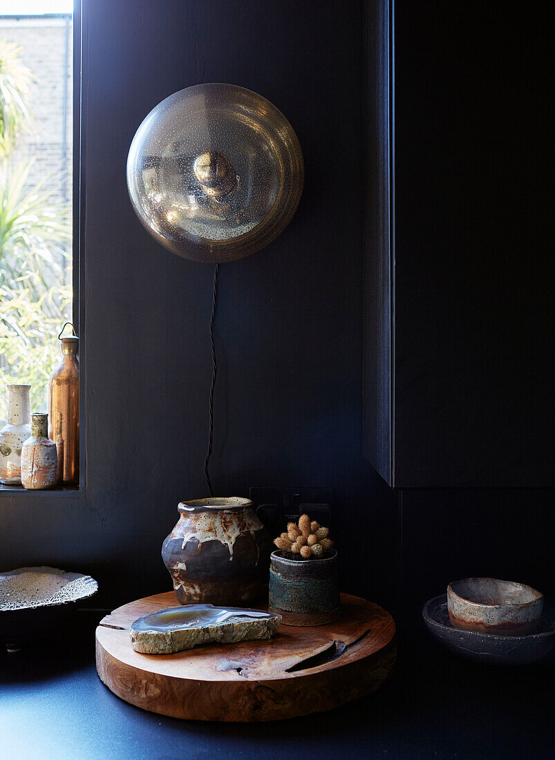 Vintage-Leuchte und Keramiktöpfe mit Holzschneidebrett in einer Küche in Ramsgate, Kent, UK