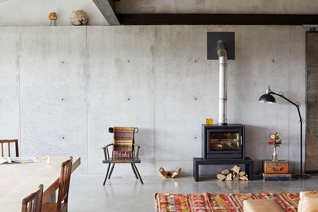 Wood burning stove and chair in open plan living room of Sligo home, Ireland