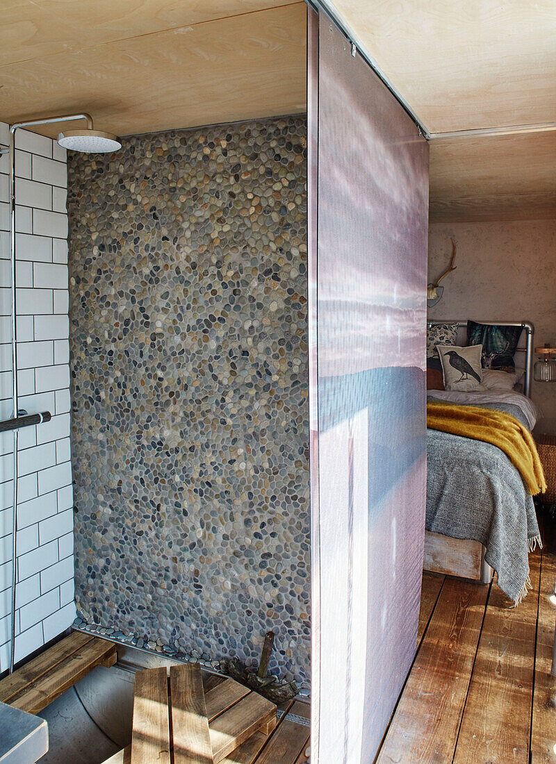Pebble dashed wall in shower cubicle converted shipping container in Bedford, UK