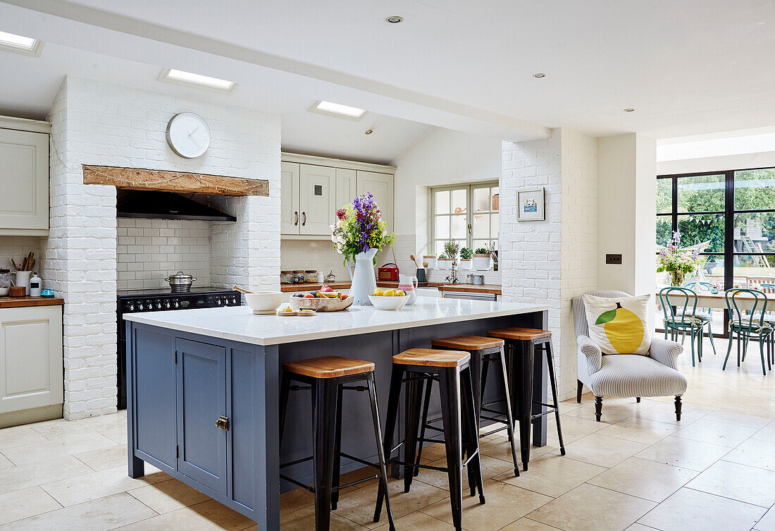 Bar stools at breakfast bar in open plan Oxfordshire kitchen, UK