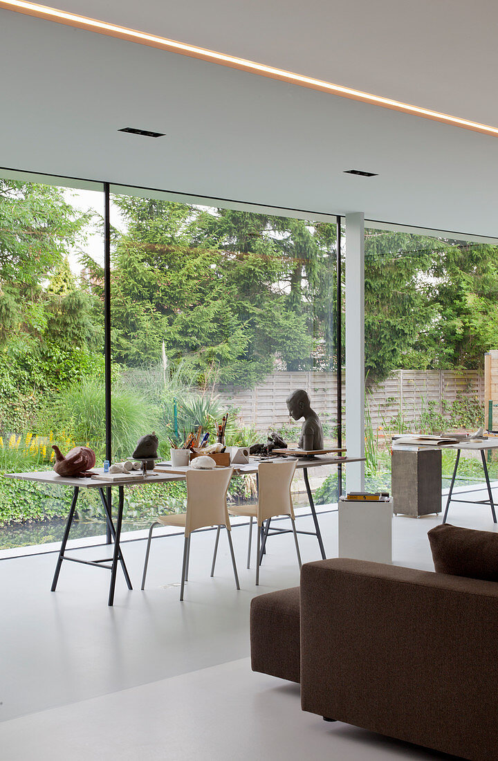 Table on trestles next to glass wall in architect-designed house