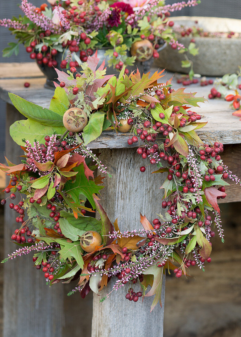 Wreath of hawthorn berries, ling, medlar fruits and leafy branches