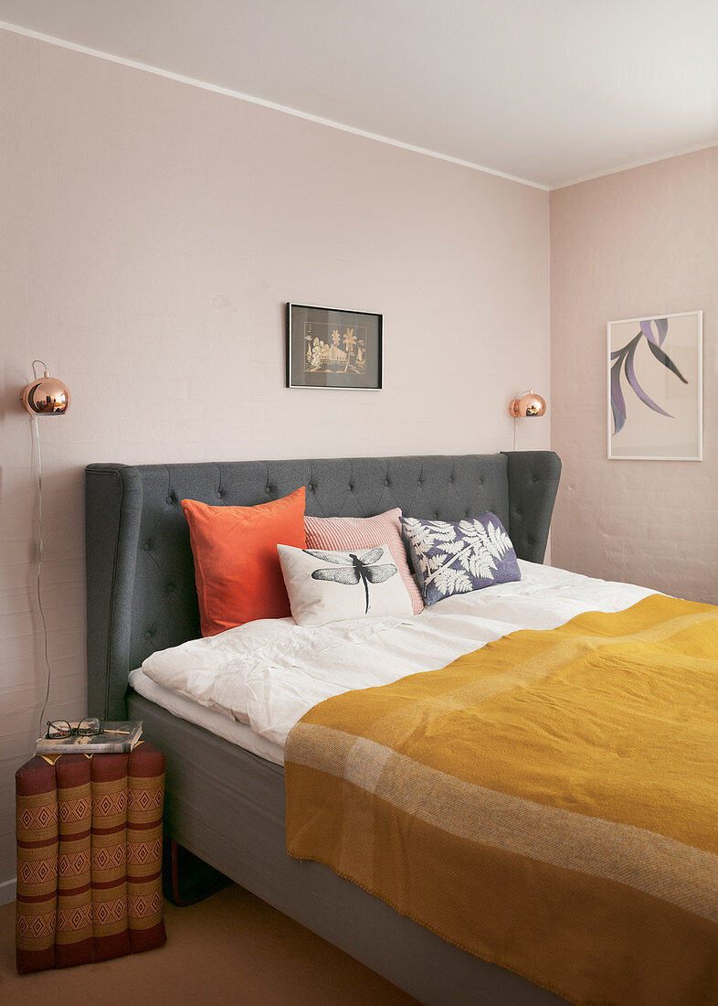 Spice shades in classic bedroom with pale pink walls