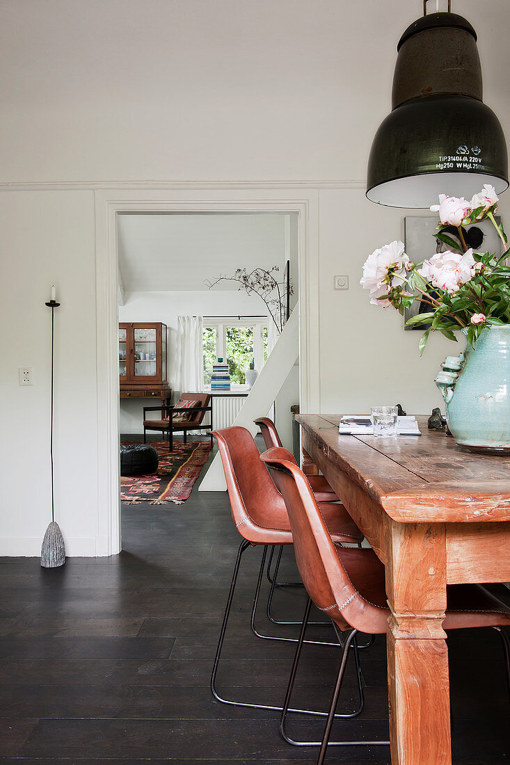 Wooden dining table, classic chairs and pendant lamp