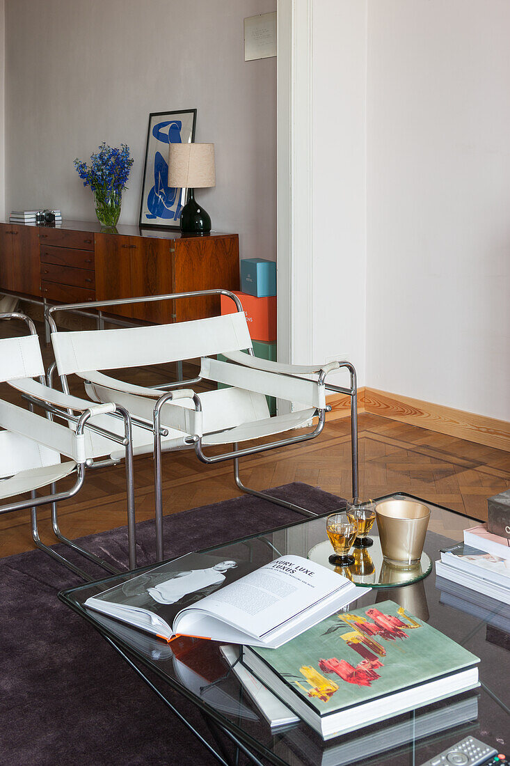 Living room with modern glass table and white and chrome chairs