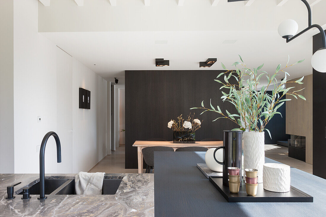 Modern kitchen with island, marble worktop and hanging designer lamp