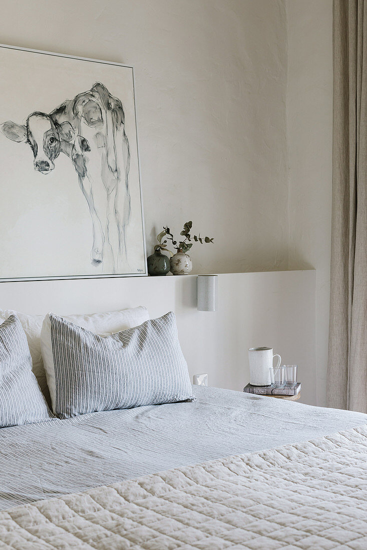 Picture of a calf on the ledge above the bed in the bedroom in white