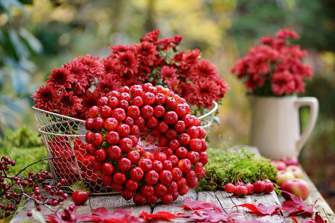 Wreath of crab apples and basket of chrysanthemums